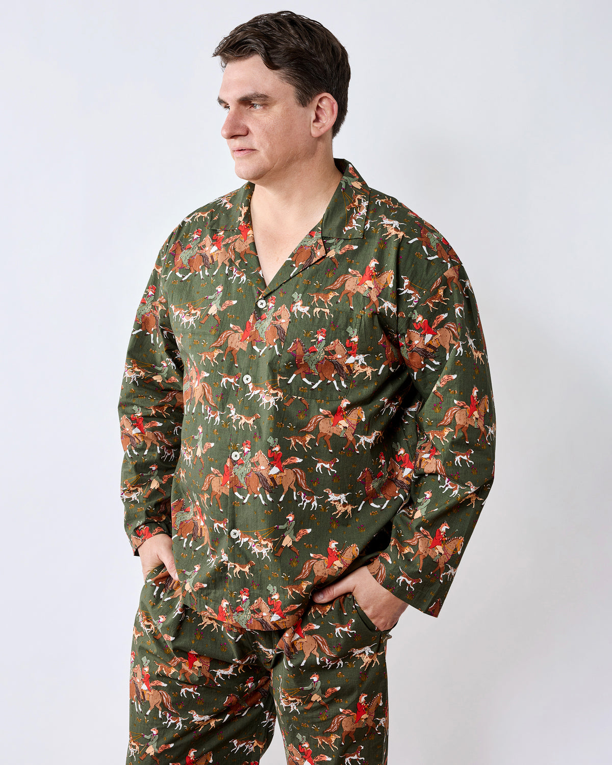 Front view of a button-down long pajama set in a green fox-and-hounds print, modeled against a light background.