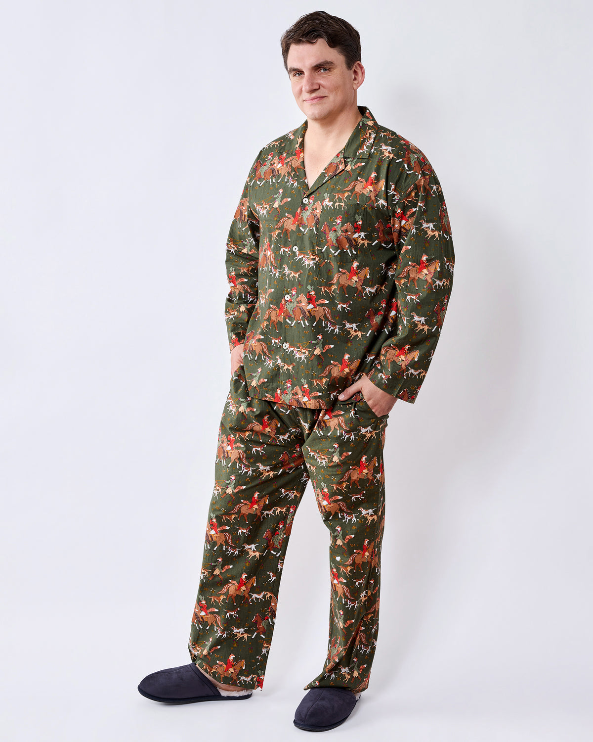 Three-quarter front view of a pine green long pajama set with a button-front shirt and matching fox-and-rider print pants.