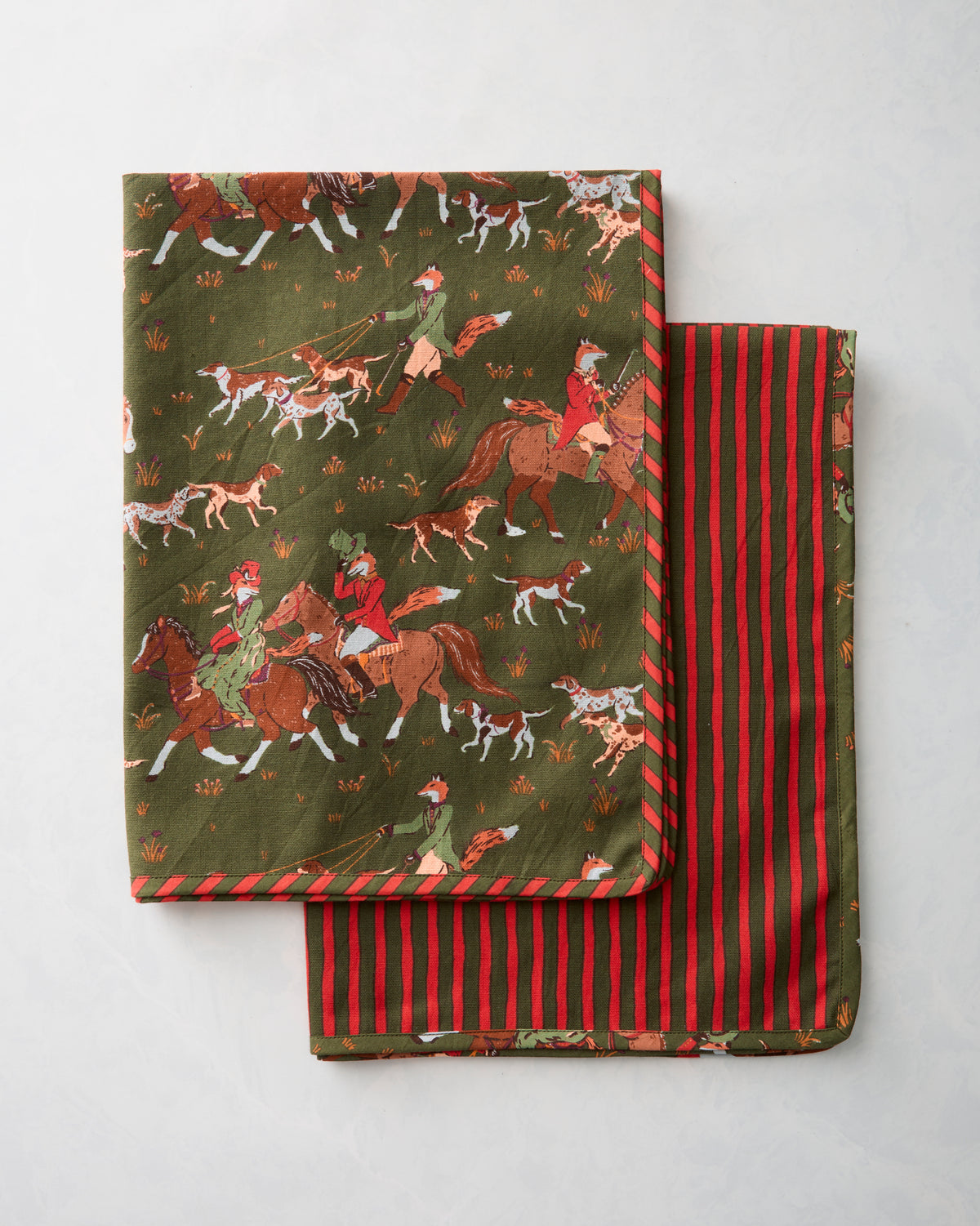 Two Fox & Hounds tea towels folded together, showing the fox-hunting print on one towel and red-and-green stripes on the other.