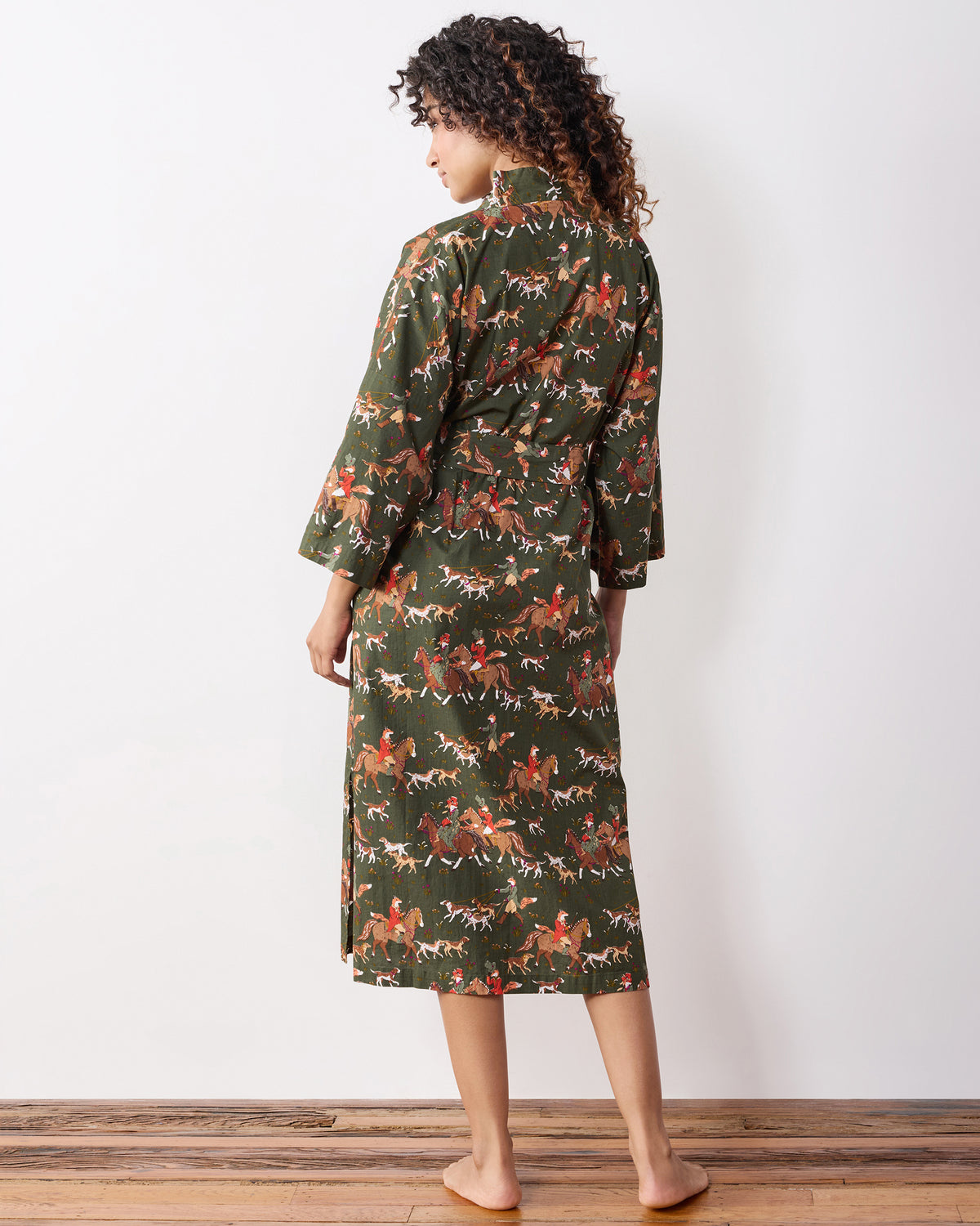 Back view of the green fox-and-hounds print long robe with a tied belt.