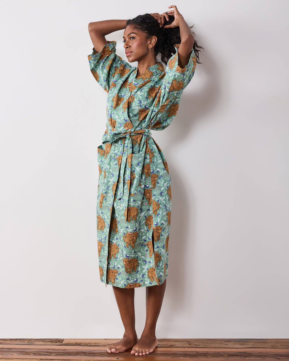 Full-length view of the green Highland Cows long robe with wide sleeves and a tied belt.