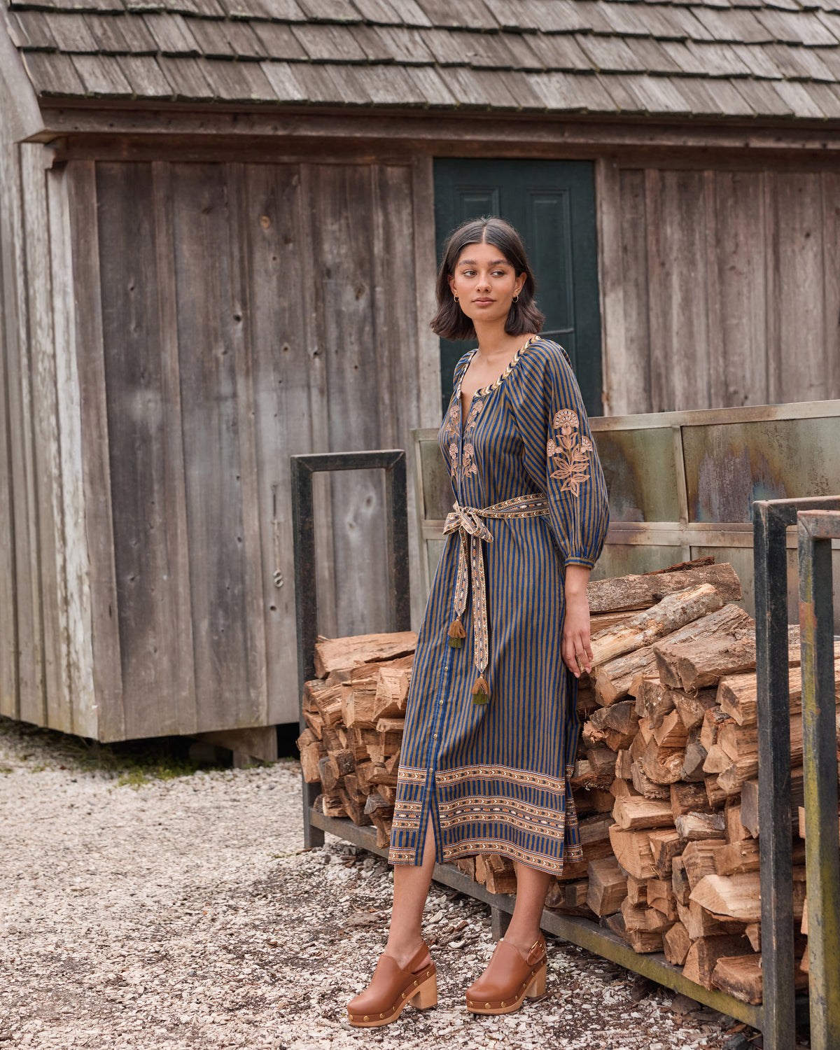 Front view of the olive-and-indigo striped Hunter midi dress with full sleeves, patterned trim, and waist belt.