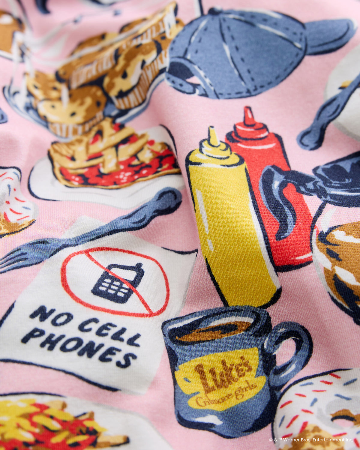 Close-up of the pink Luke’s Diner print featuring food, coffee, clothing, and a no-cell-phones sign.
