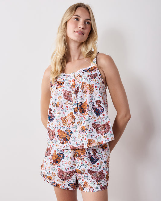 Front view of a printed short pajama set with a camisole-style top and ruffled shorts.