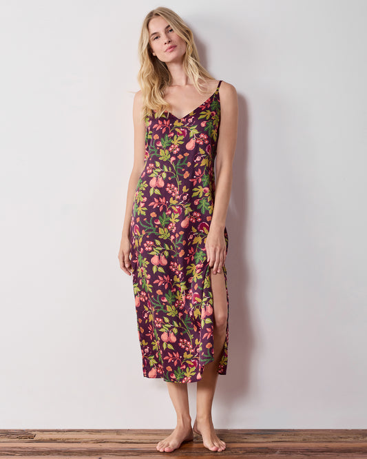 Front view of a person wearing a plum floral-print nightie with a side slit