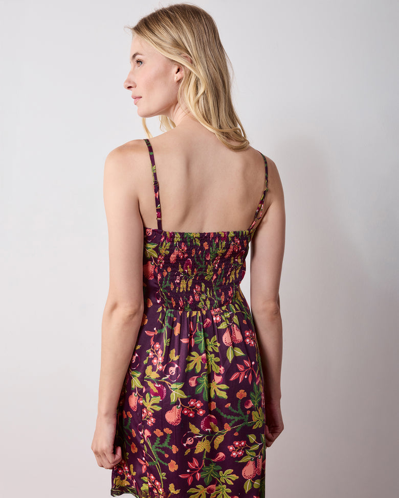 Back view of a plum floral-print nightie with thin straps and a gathered back panel