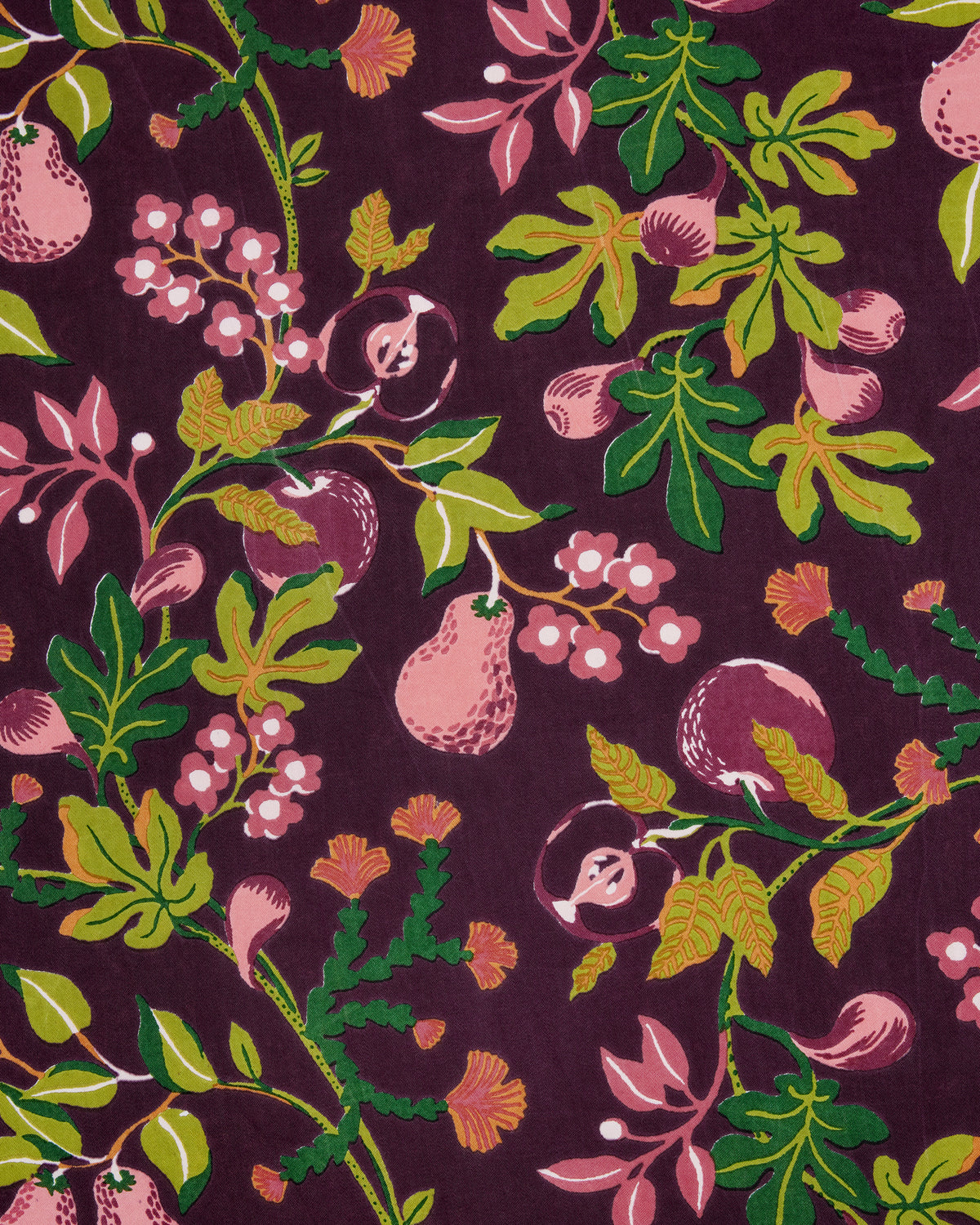 Close-up of the Pomme & Poire apron’s plum fabric print with fruit, flowers, leaves, and vines.