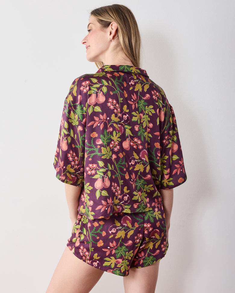 Back view of the plum Pomme & Poire Sweet Dreams short pajama set with a fruit-and-floral print.