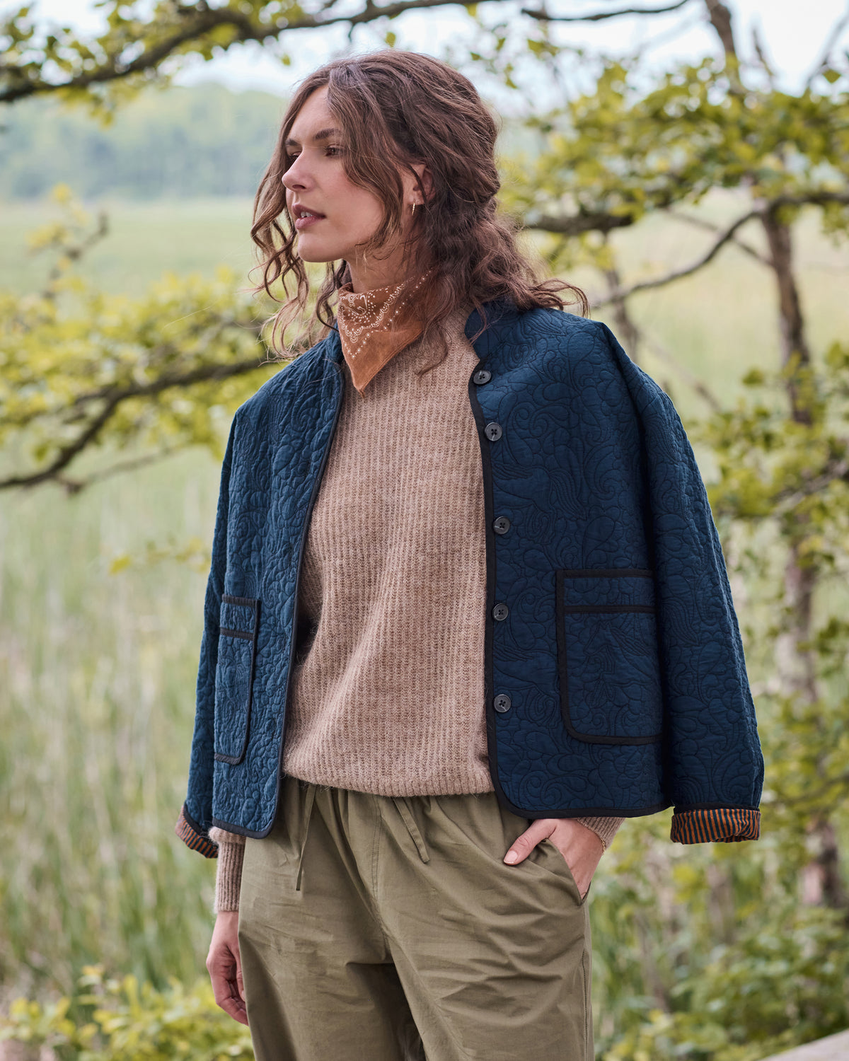 Front three-quarter view of the vintage indigo Elliott jacket with snap buttons, quilted pattern, and two large patch pockets.