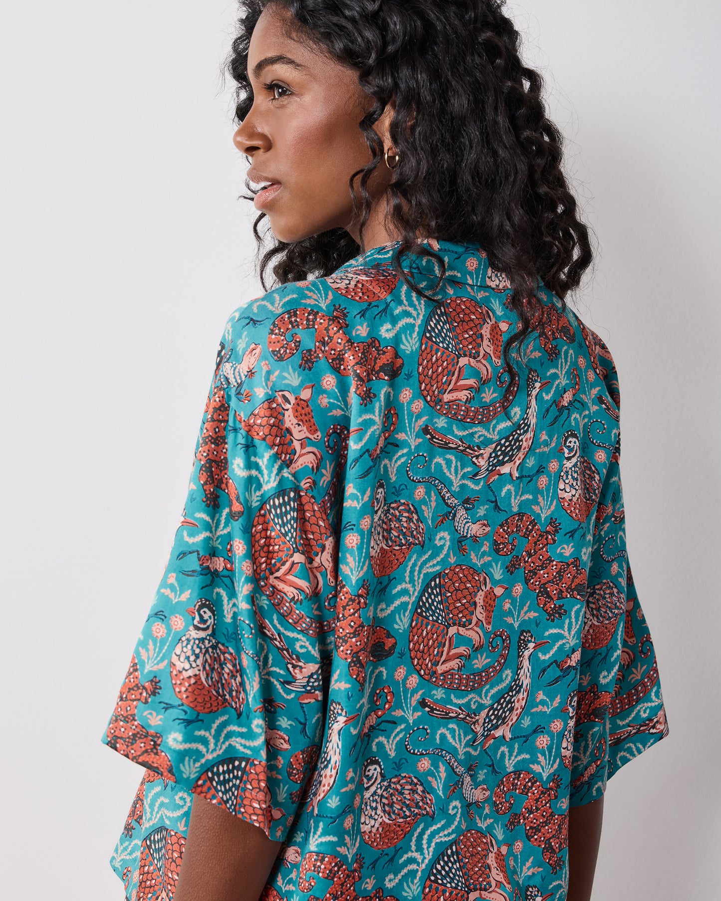 Close back view of the teal patterned short-sleeve pajama top.