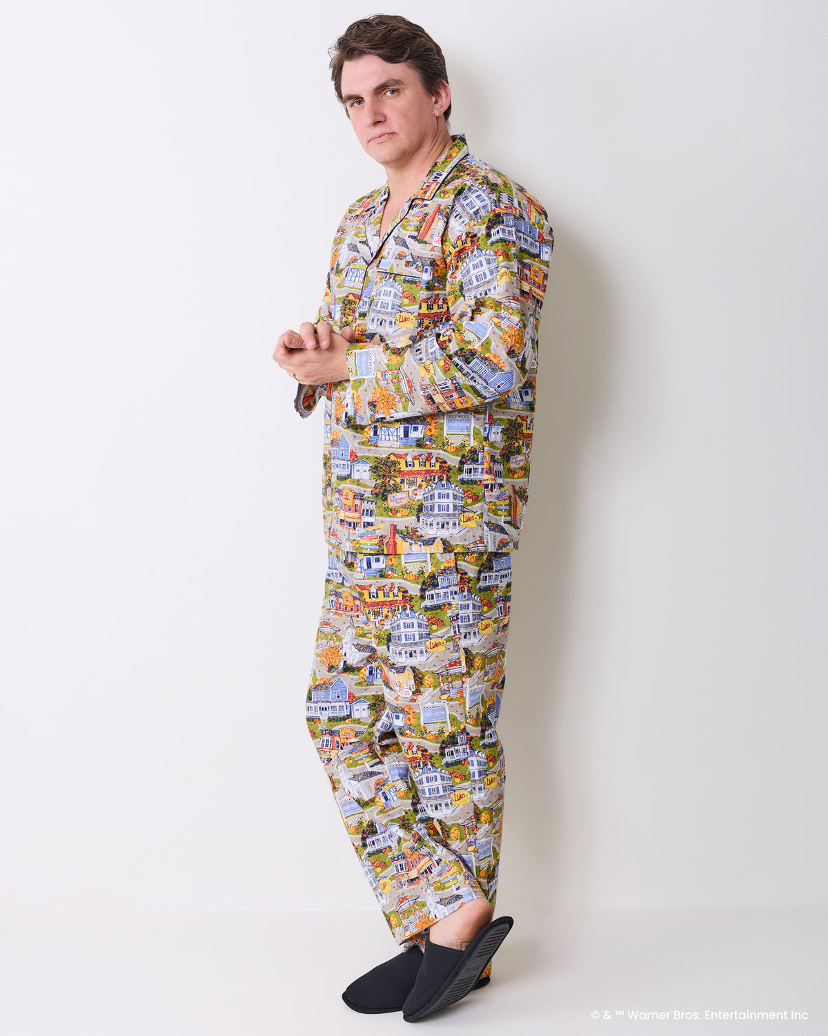 Side view of a person wearing the long-sleeve Stars Hollow illustrated pajama set with matching shirt and pants.