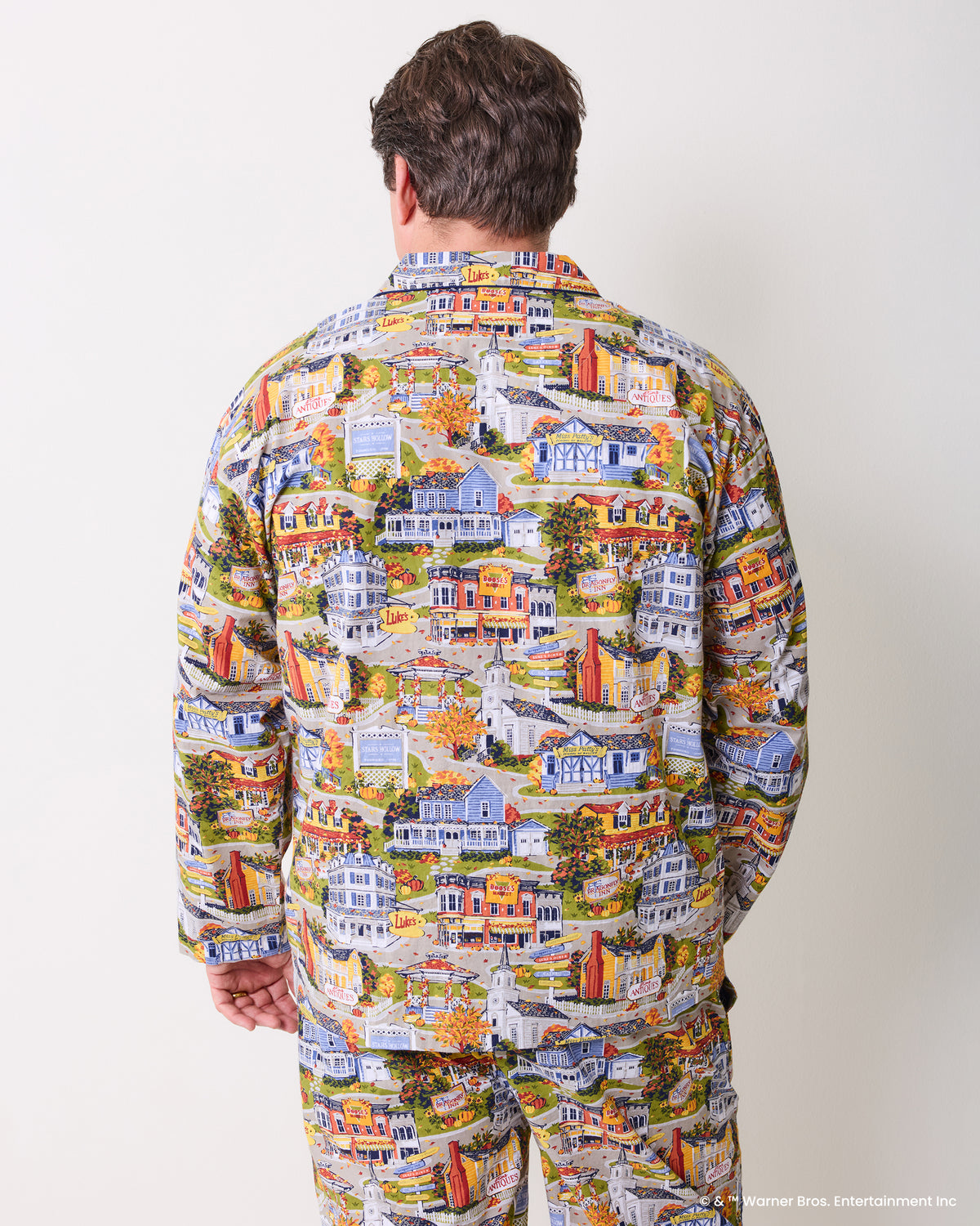 Back view of a person wearing the long-sleeve Stars Hollow illustrated pajama set with a matching shirt and pants.