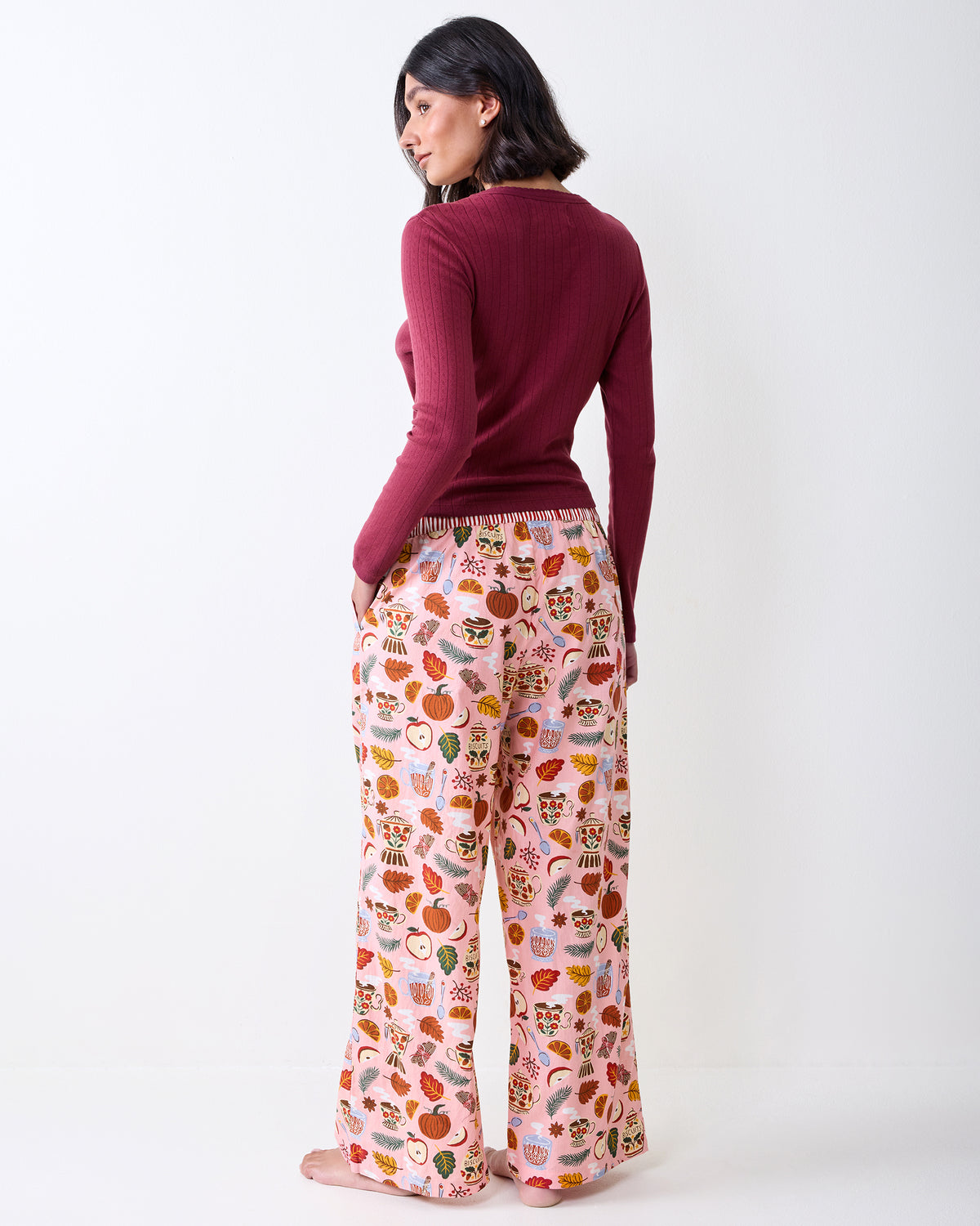 Back view of a person wearing printed wide-leg pajama pants, showing the rear fit and full-length legs.