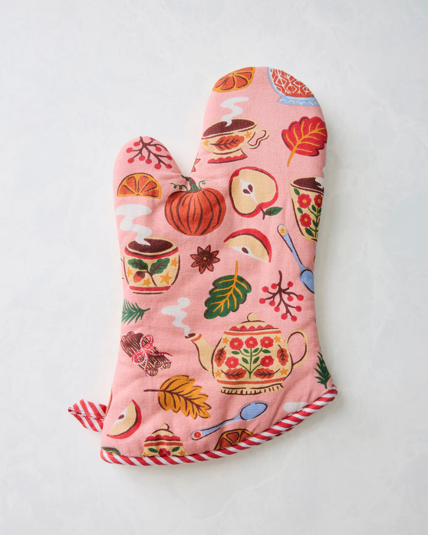 Rose-pink printed oven mitt with red-and-white striped edging and loop.