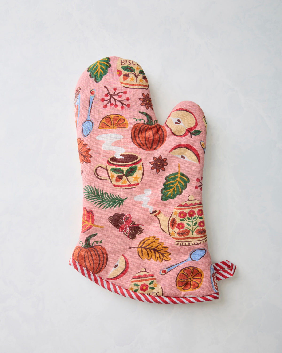 Reverse side of a rose-pink printed oven mitt with red-and-white striped edging and loop.