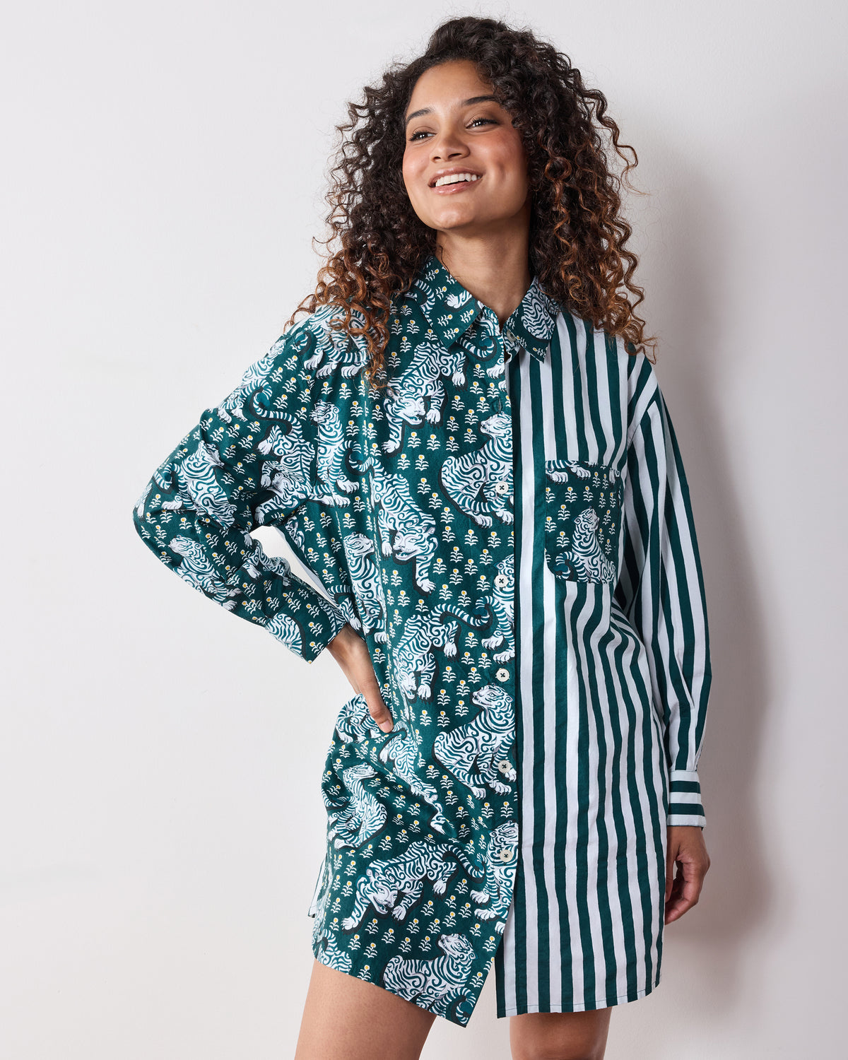 Front three-quarter view of the Tiger Queen button-down shirt with tiger-print and green-and-white striped panels, buttons, and chest pocket.