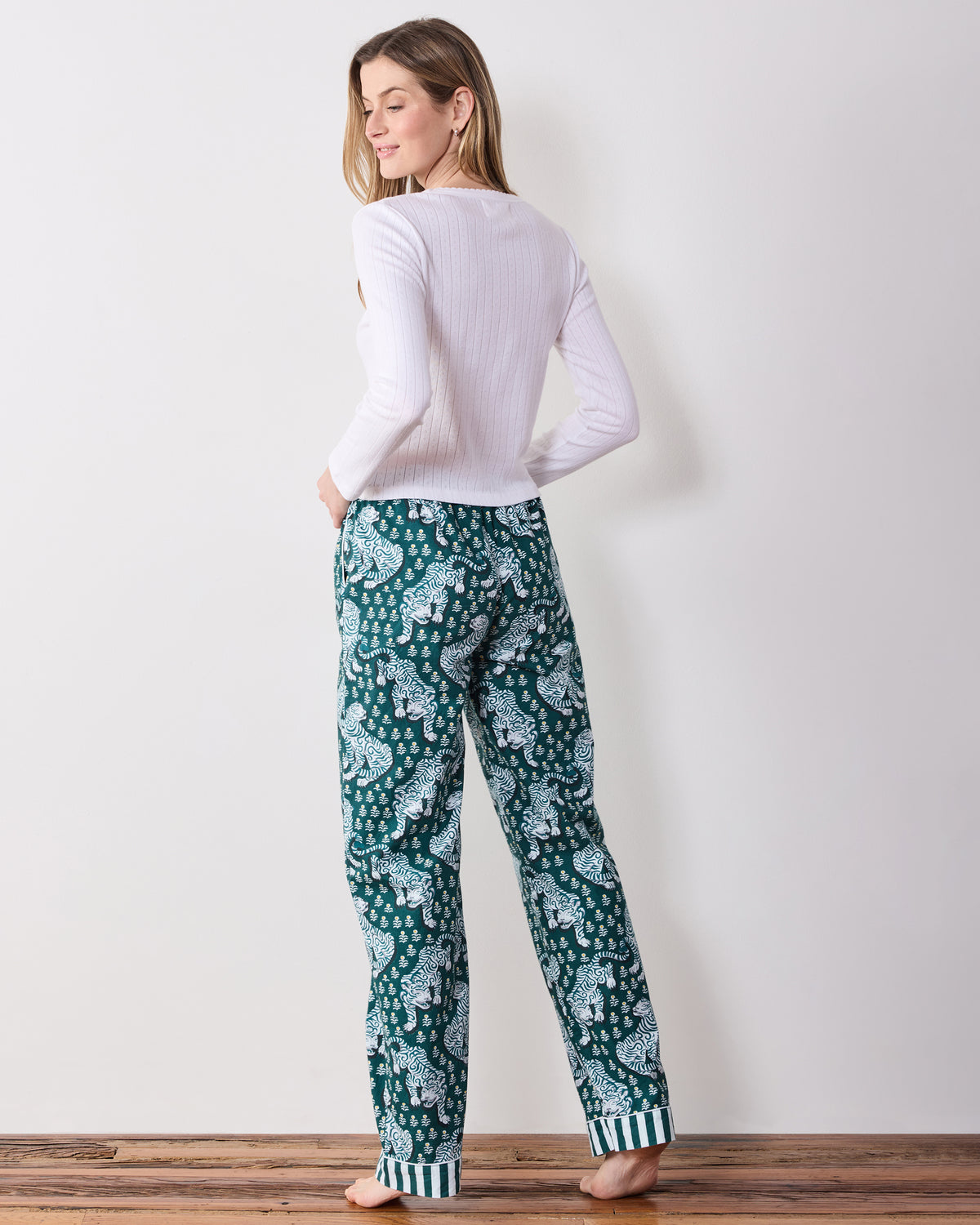 Back view of the full-length Tiger Queen pajama pants showing the all-over tiger print and striped ankle cuffs.