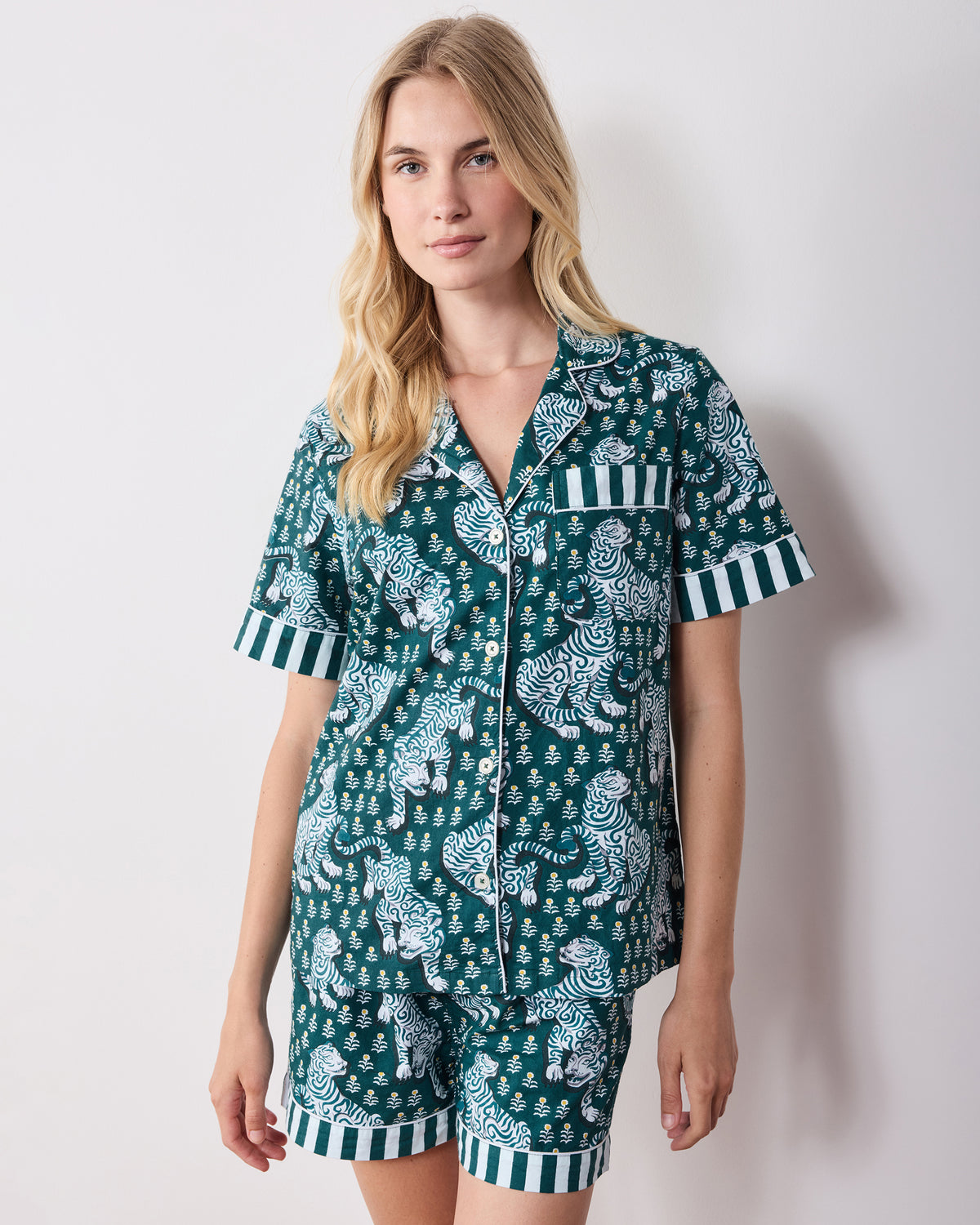 Front view of the green tiger-print short pajama set showing the button-front top, striped chest pocket, and matching shorts.