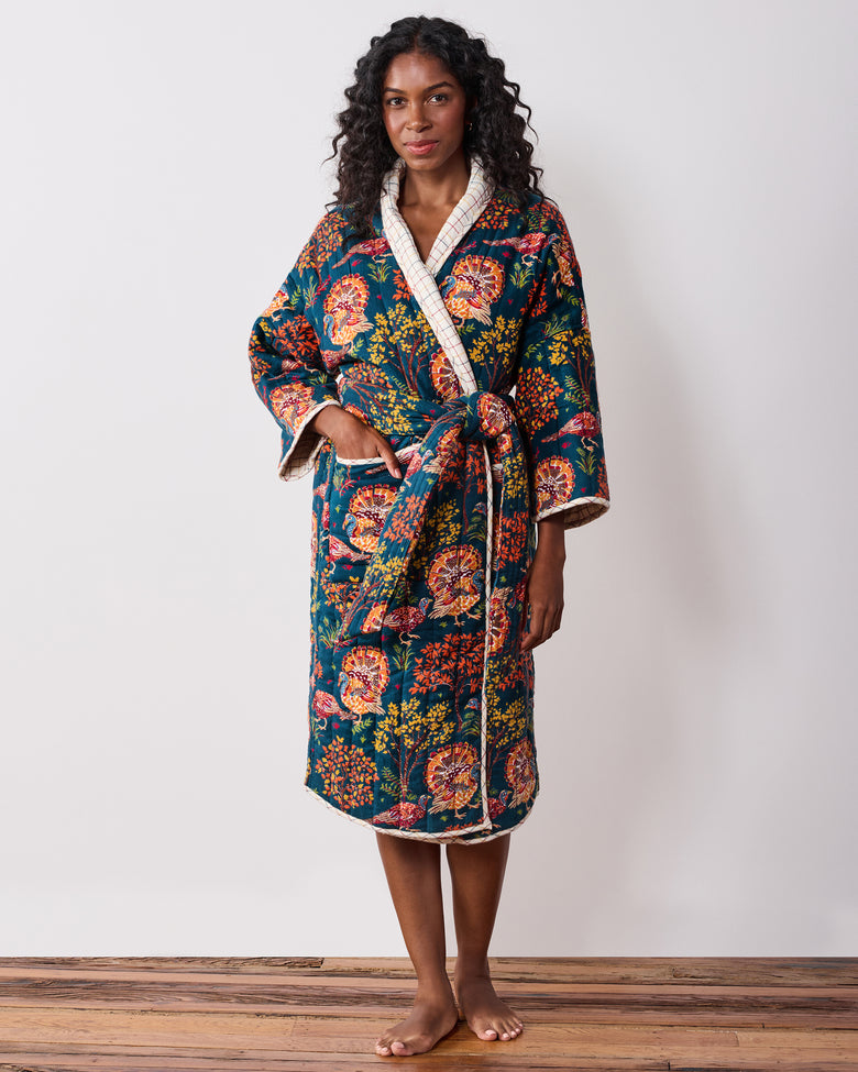 Front view of a navy Turkey Trot robe with colorful turkey-and-floral print, plaid trim, waist tie, and front pockets.