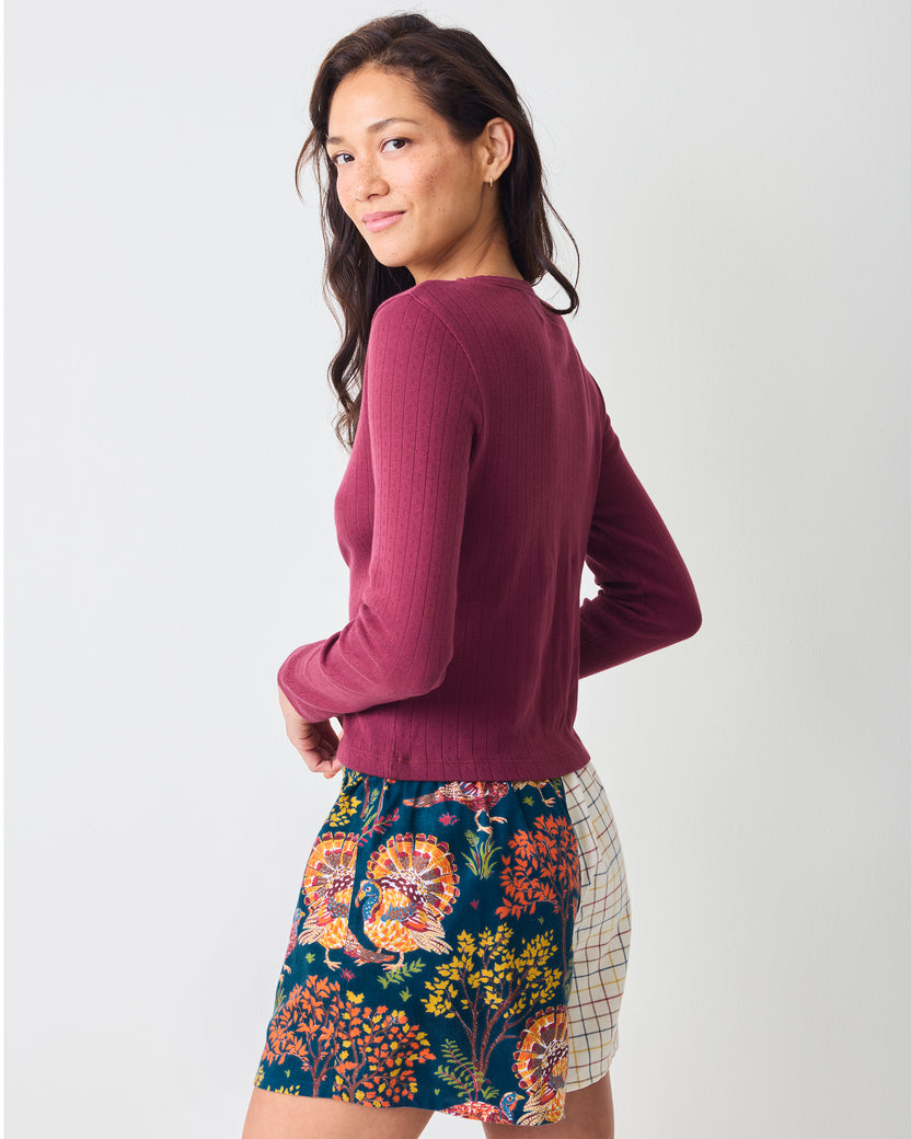 Back view of Turkey Trot navy boyfriend boxer shorts with a colorful turkey-and-floral print and contrasting plaid side panel.