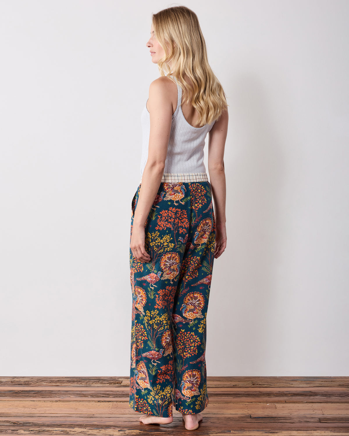 Back view of the navy Turkey Trot wide-leg pajama pants showing the rear fit and turkey and foliage print.