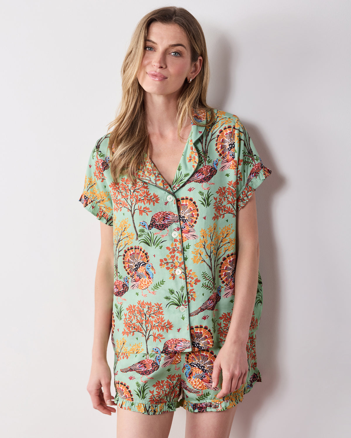 Front view of the Soft Sage Turkey Trot short pajama set with a collared, button-front ruffled top and matching printed shorts.