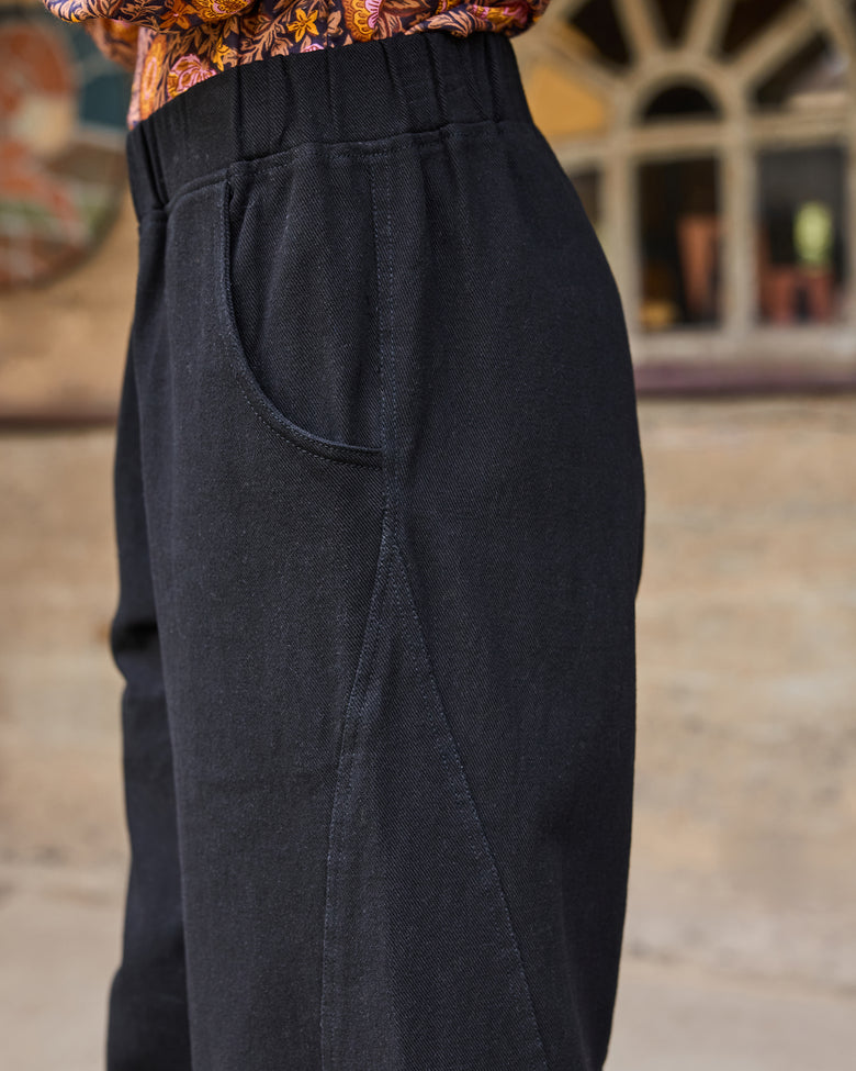 Close-up of the Wilder Pant showing the elastic waistband, side pocket opening, and stitching detail.