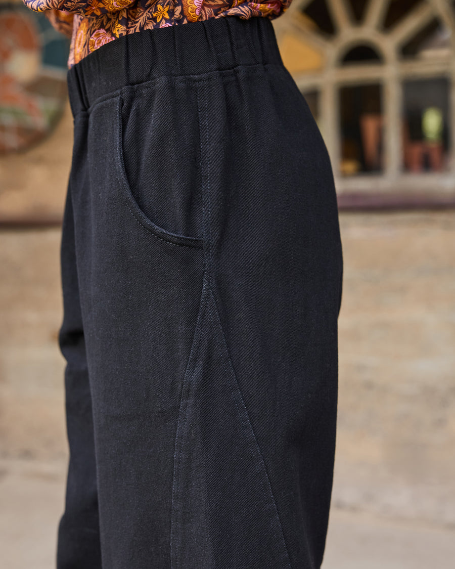 Close-up of the Wilder Pant showing the elastic waistband, side pocket opening, and stitching detail.
