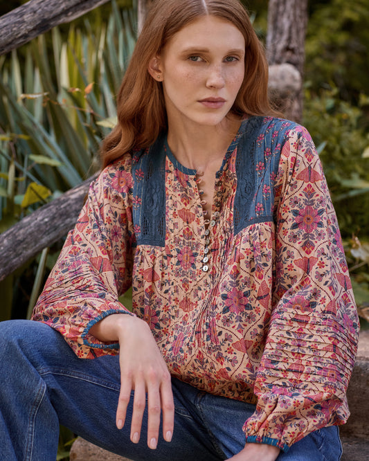 Close front view of the Winged Tapestry Denver blouse showing the floral print, blue yoke panels, button placket, and sleeve gathering.