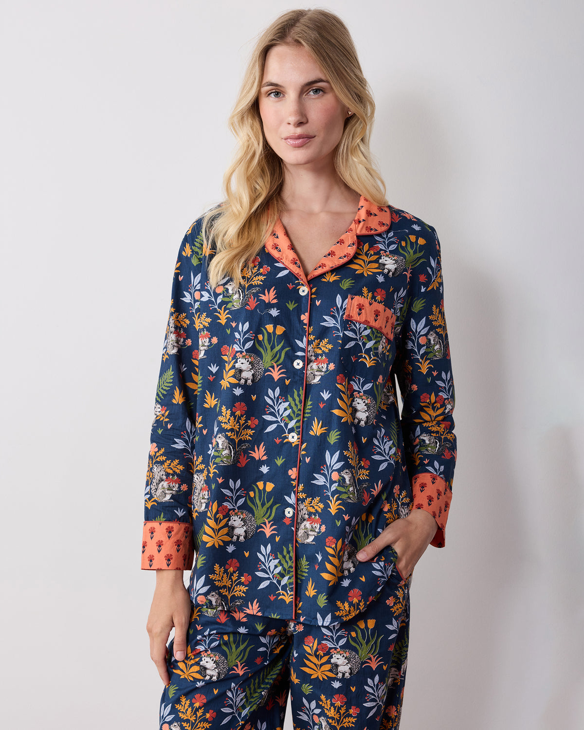 Front view of the Woodland Critters indigo long pajama set showing the button-front top, chest pocket, side pockets, and matching pants.