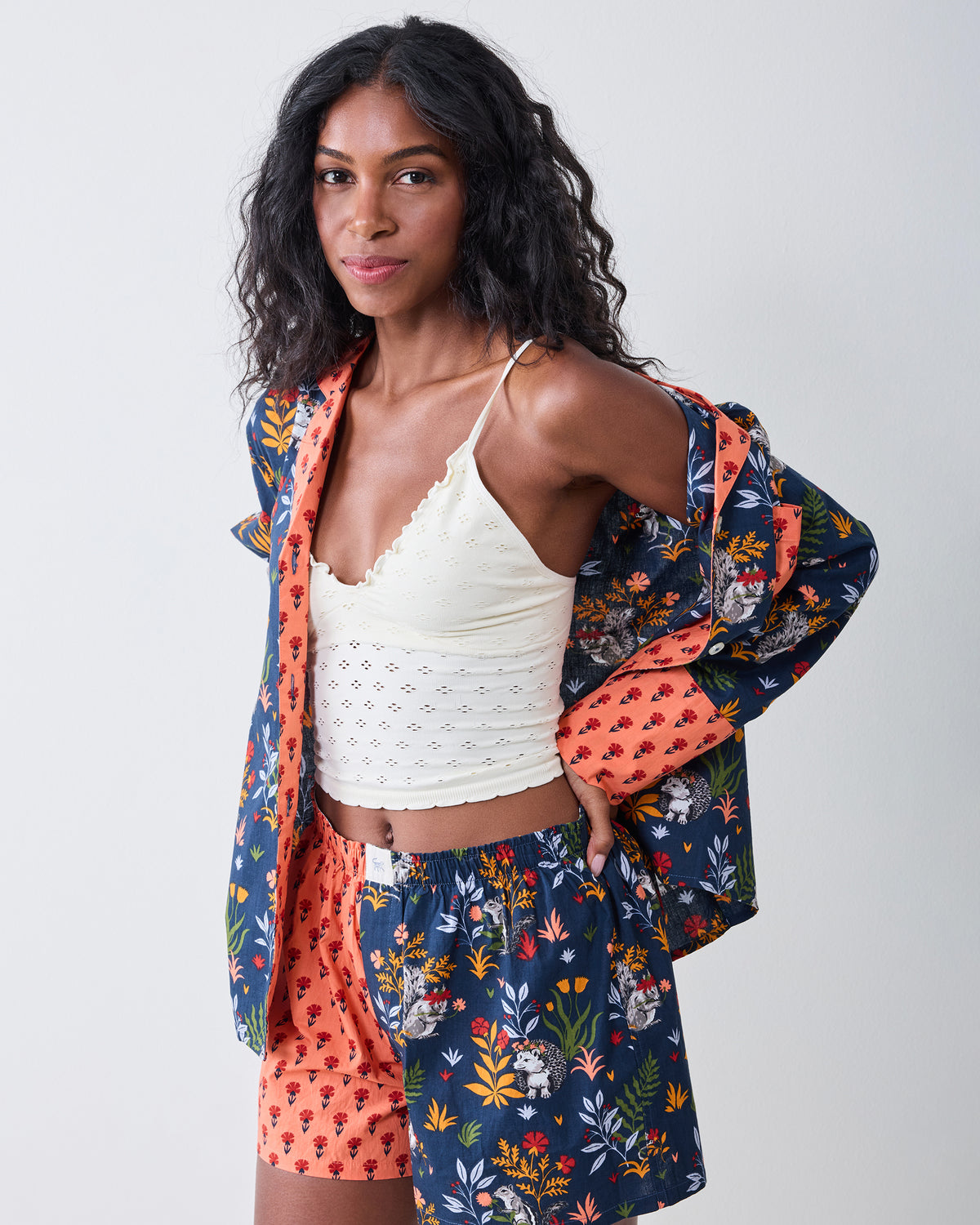 Person modeling the indigo Woodland Critters pajama set with a long-sleeve button-front top and coordinating shorts.