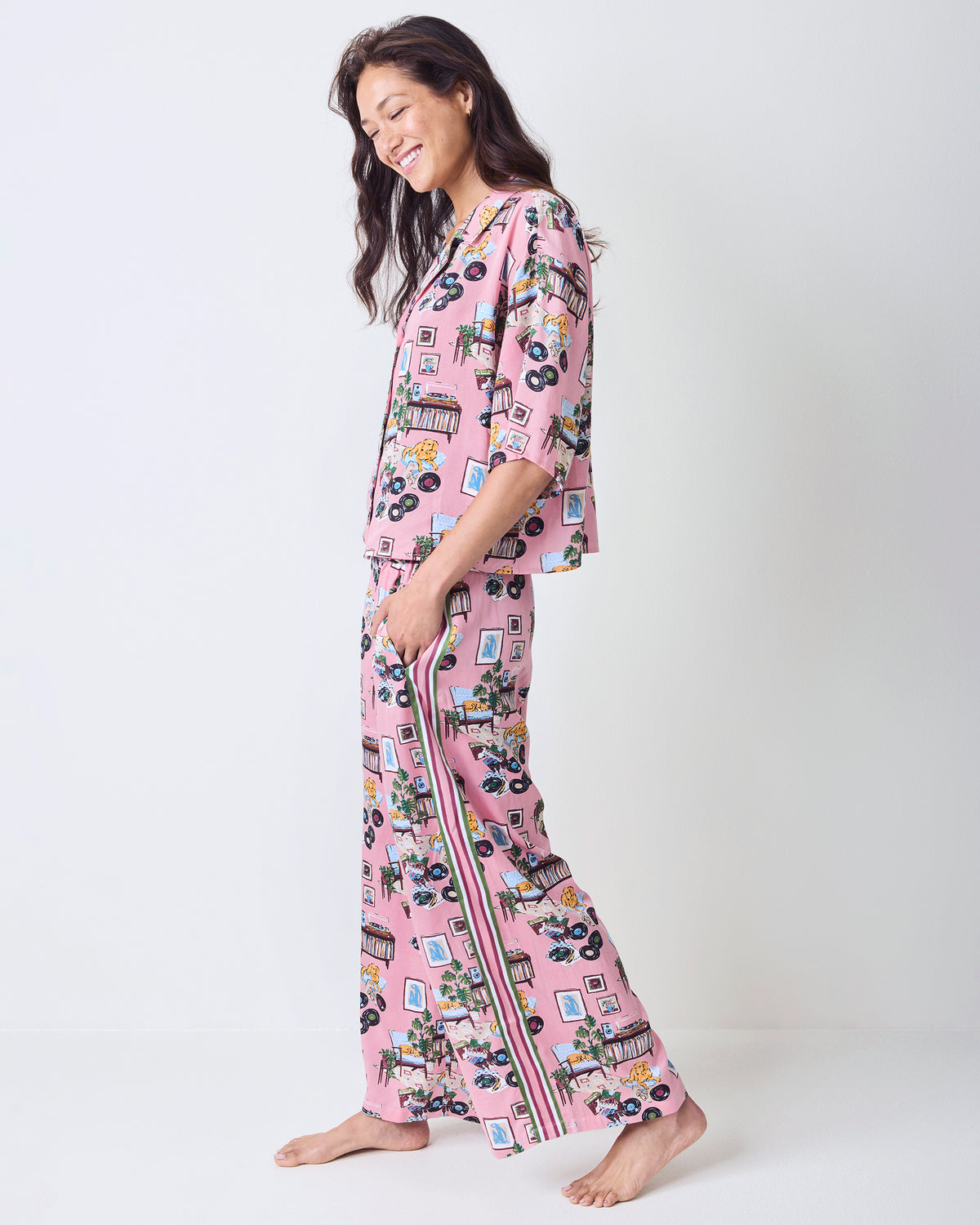 Side view of the pink printed Tall Eco Satin Wildest Dreams pajama set with a cropped top and wide-leg pants.