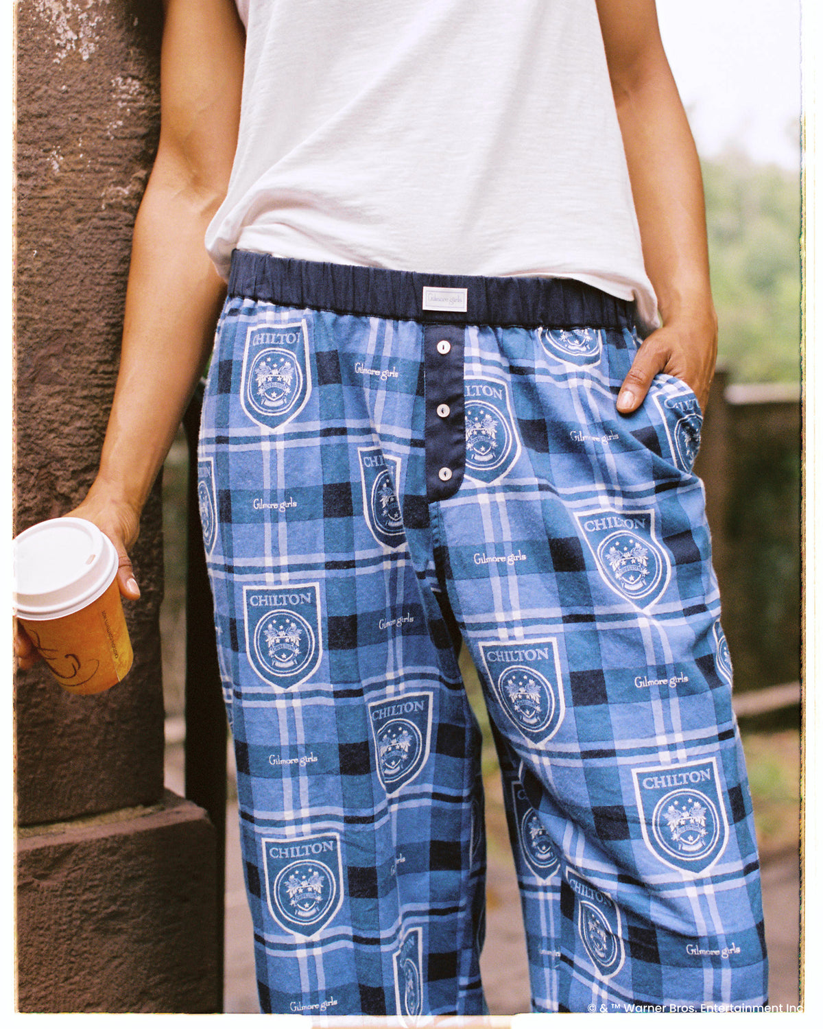 Close-up of the blue plaid Chilton pajama pants showing the front button fly, elastic waistband, and side pocket.