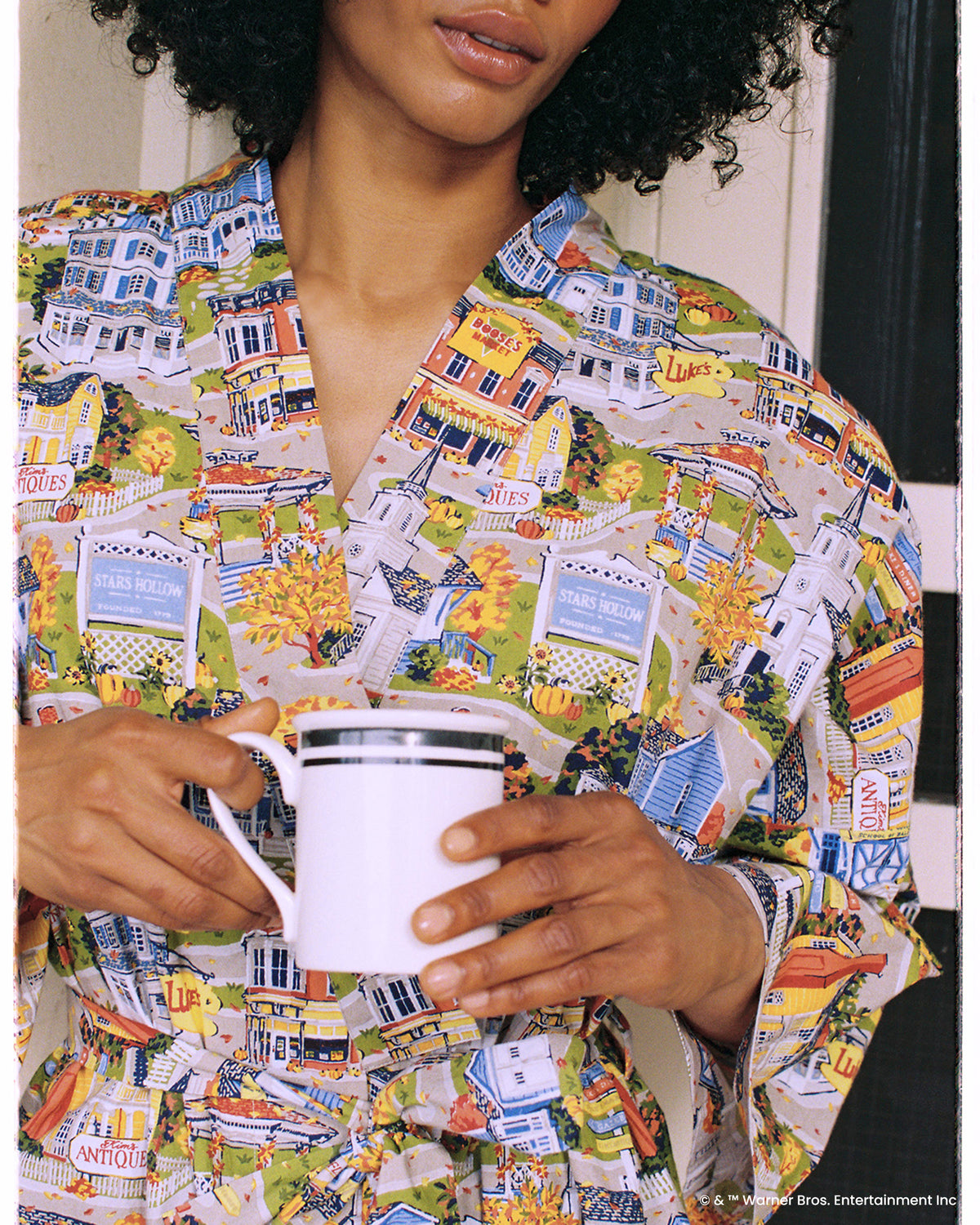 Close view of the Stars Hollow robe's illustrated town print and overlapping front panels.