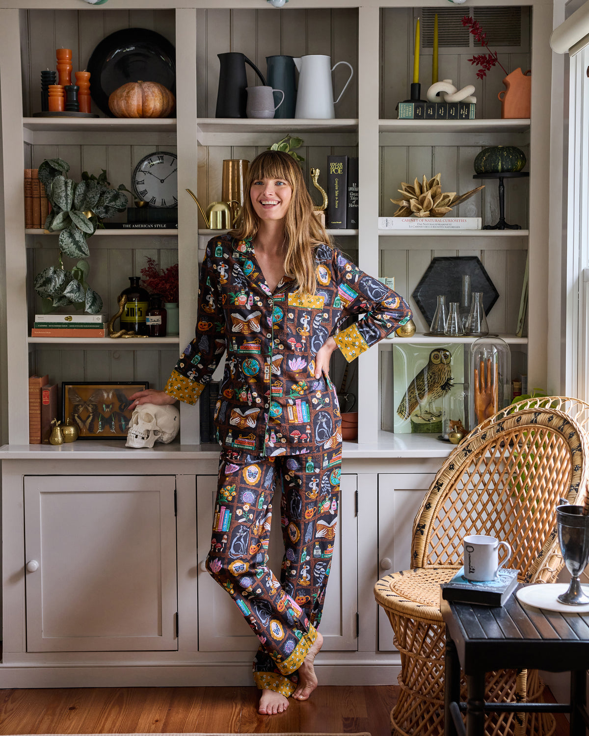 Front view of the Enchanted Study petite long pajama set, showing the button-down top, relaxed pants, and illustrated cabinet-of-curiosities print.