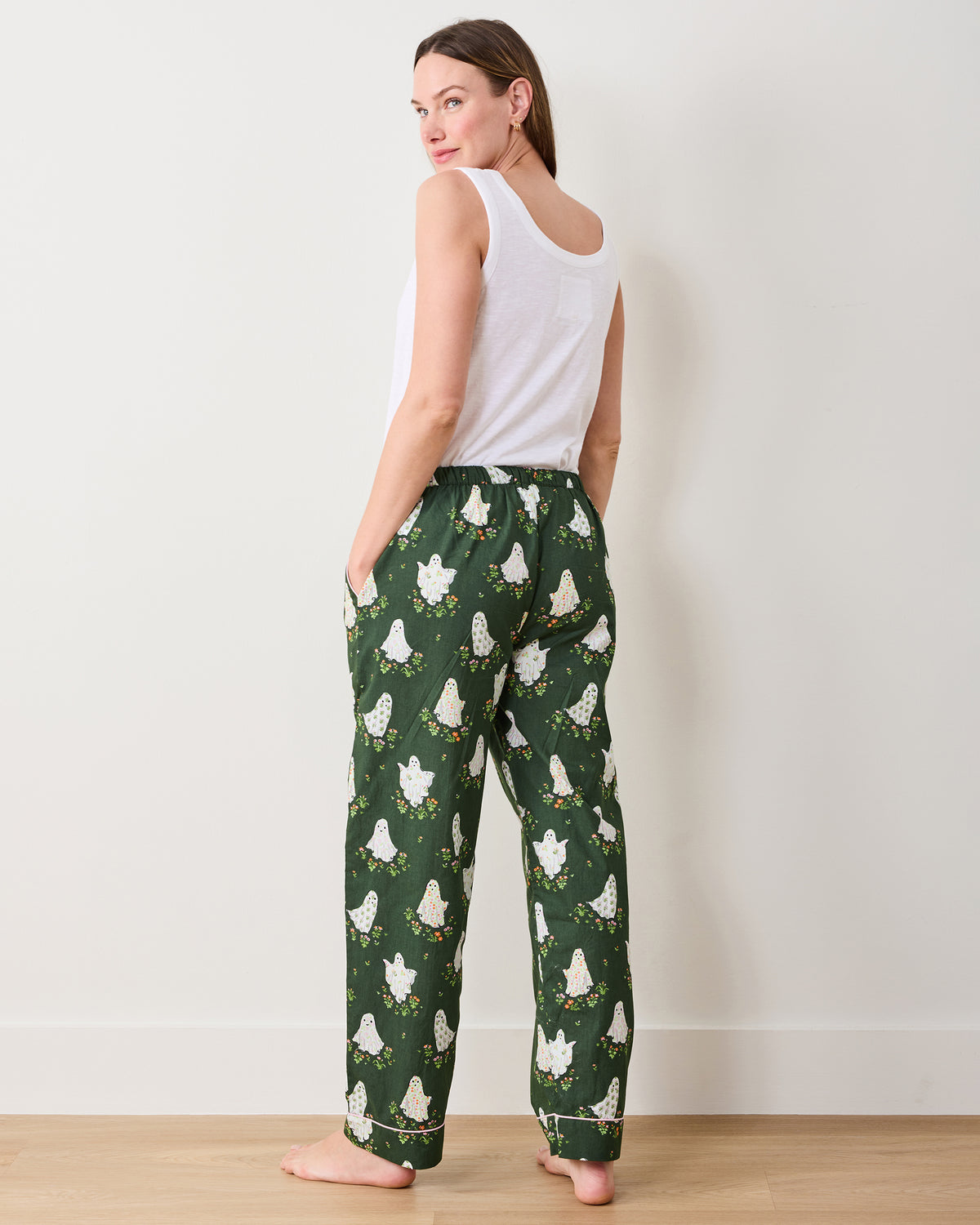 Back view of Overgrown Moss Gardening Ghosts pajama pants with an allover ghost-and-flower print and contrasting cuff trim.