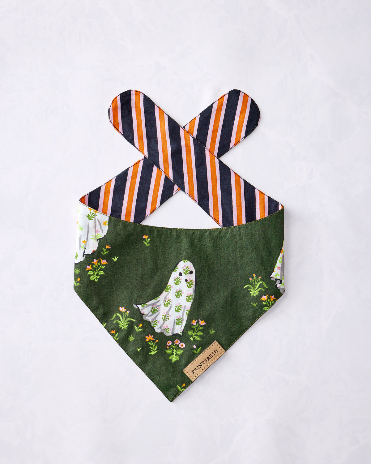 Pet bandana displayed flat with a green ghost-and-floral print, striped ties, and PRINTFRESH label.