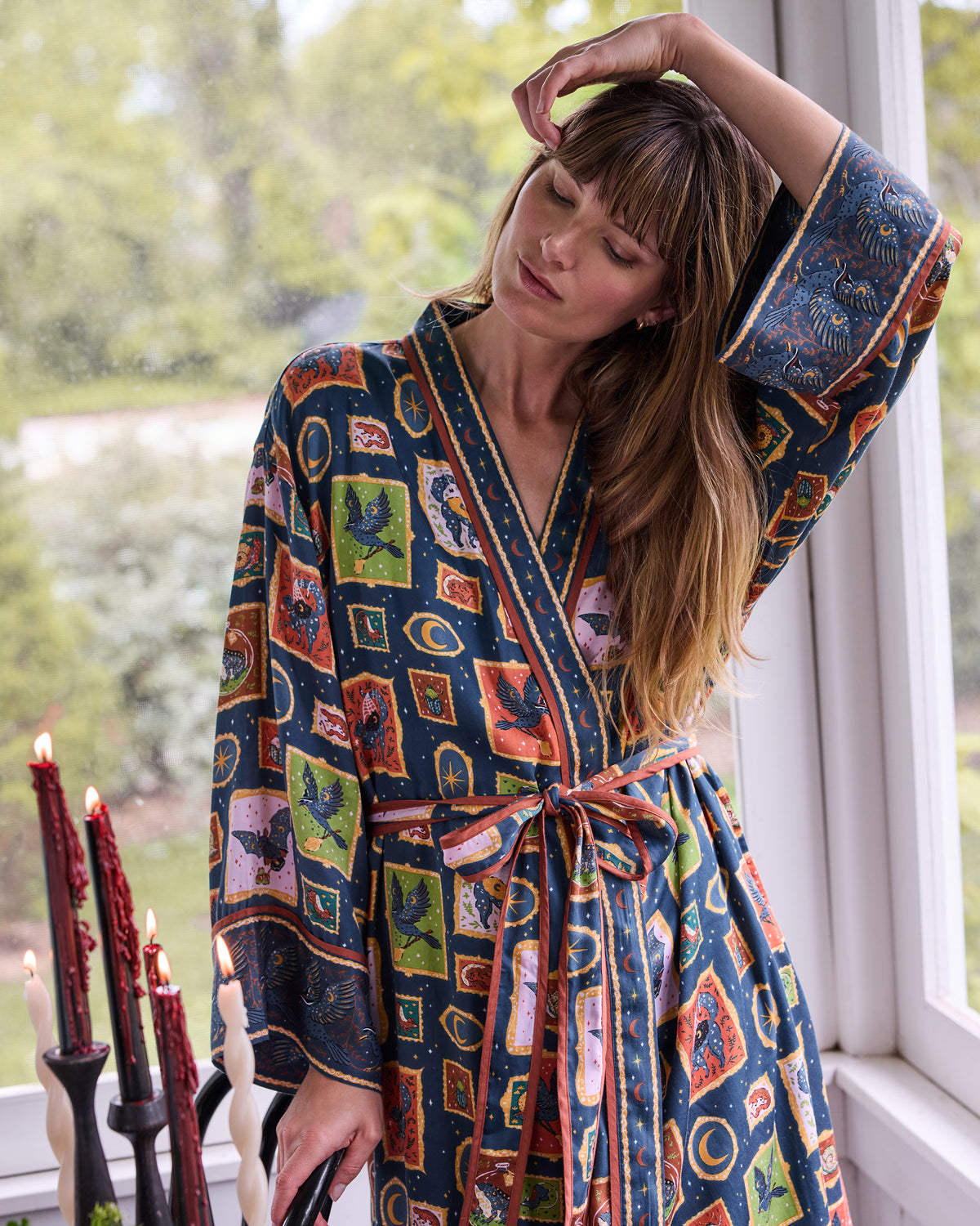 Front view of the Midnight Gallery patterned wrap robe tied with a contrast-trim sash.