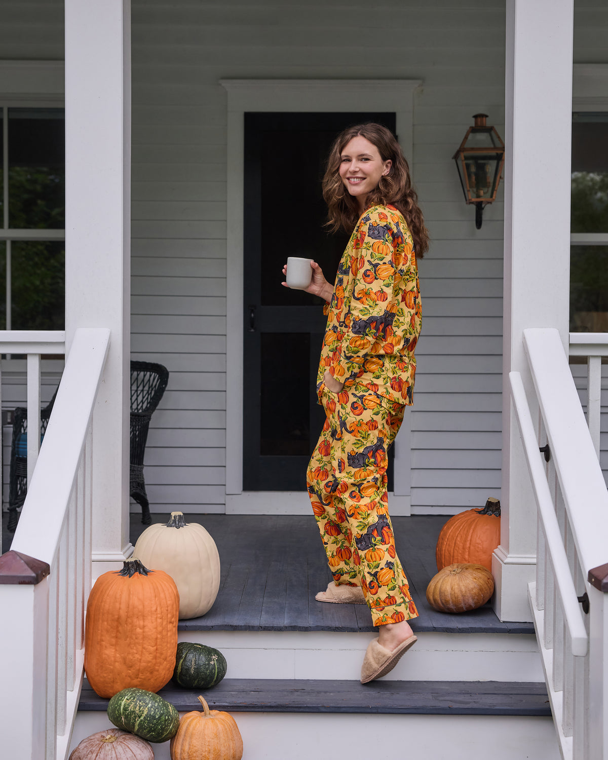 Side view of the Pumpkin Prowl long pajama set with a printed button-front top and matching pants.