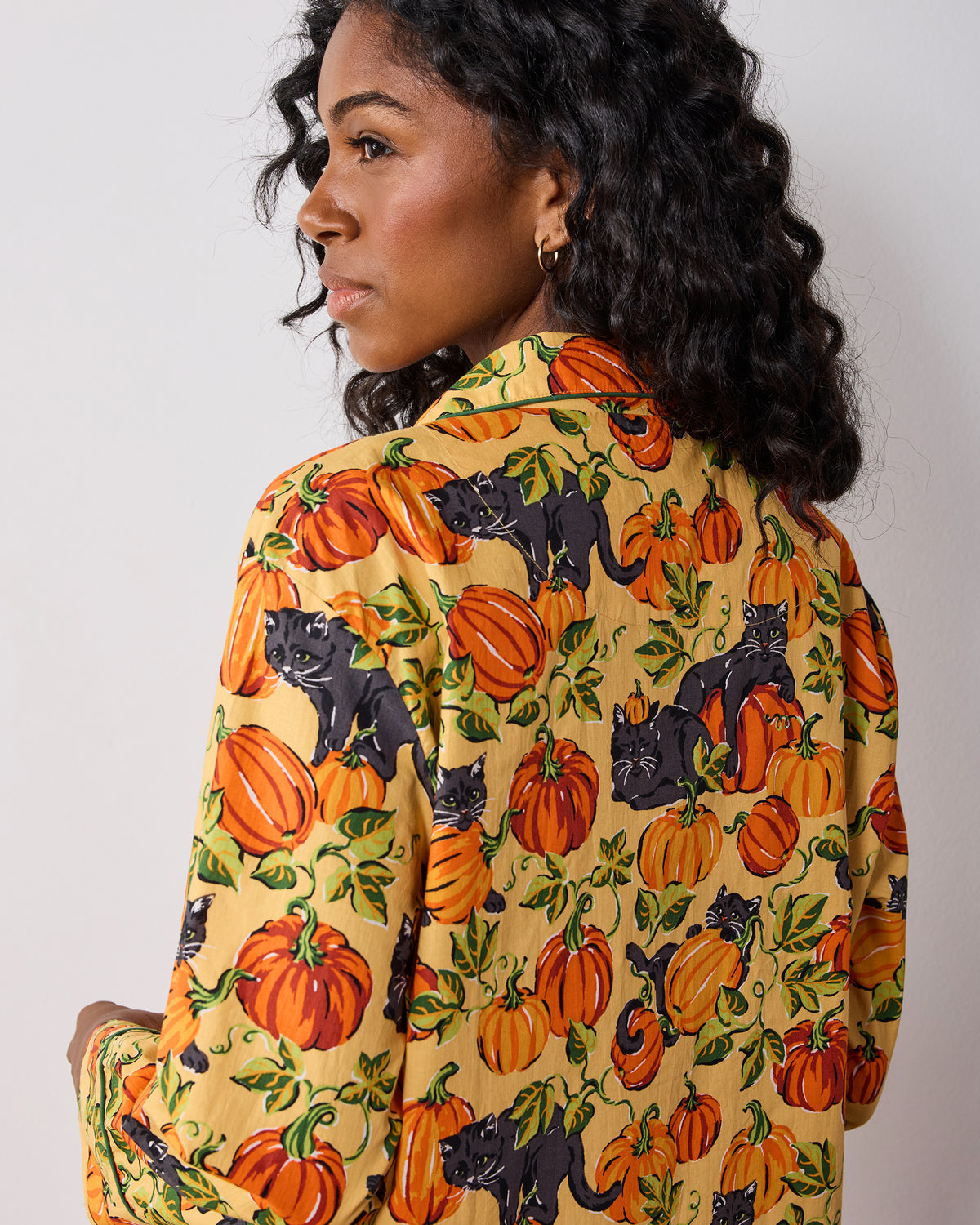 Back view of the Pumpkin Prowl long pajama set showing the pumpkin, black cat, and vine print across the top and pants.
