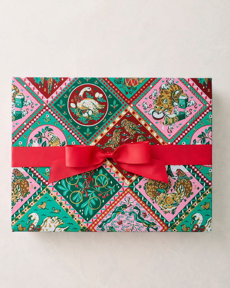 12 Days of Christmas gift box with a multicolored vintage holiday patchwork print and red ribbon