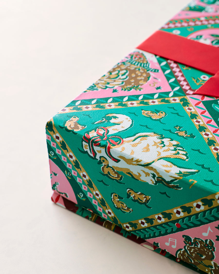 Close-up of the patterned handmade gift box with a red ribbon.