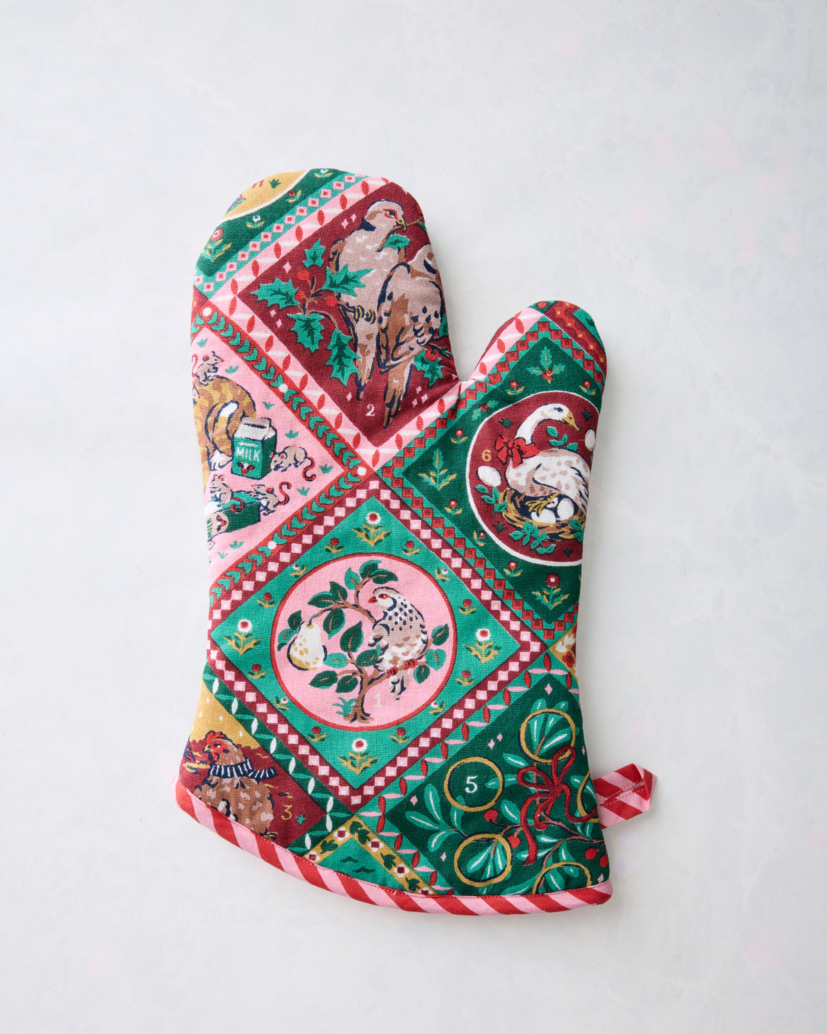 Christmas-themed oven mitt with colorful illustrated animal scenes, ornaments, and red-and-white striped edging.