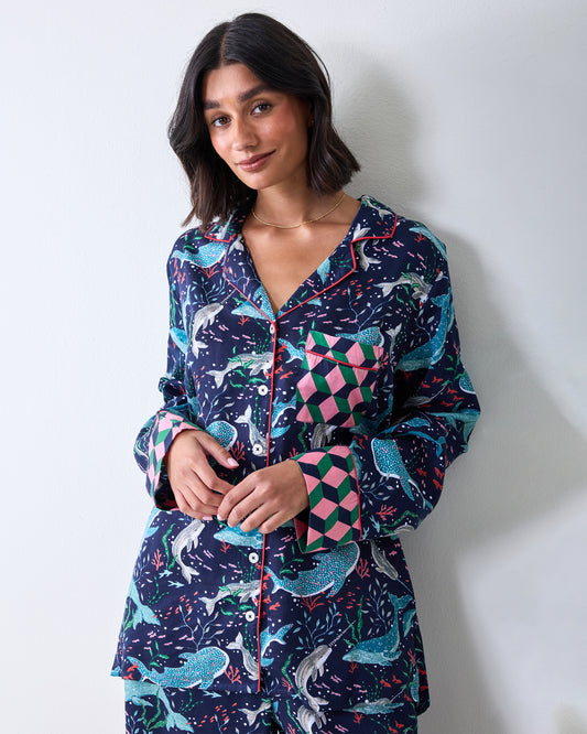 Person wearing the Blue Chill Arctic Sea Life Eco Satin Rittenhouse pajama set with a button-front top, patch pocket, and wide-leg pants.