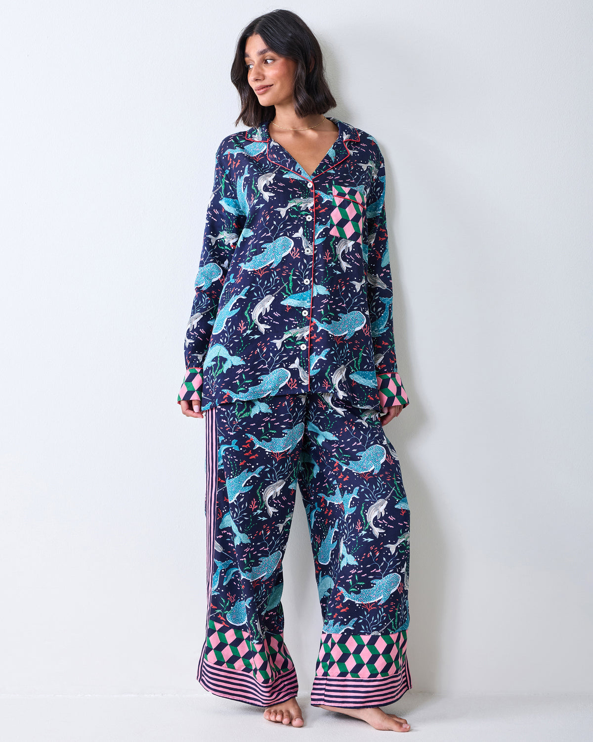 Full-length view of a person wearing the Blue Chill Arctic Sea Life Eco Satin Rittenhouse pajama set with wide-leg pants and patterned cuffs.