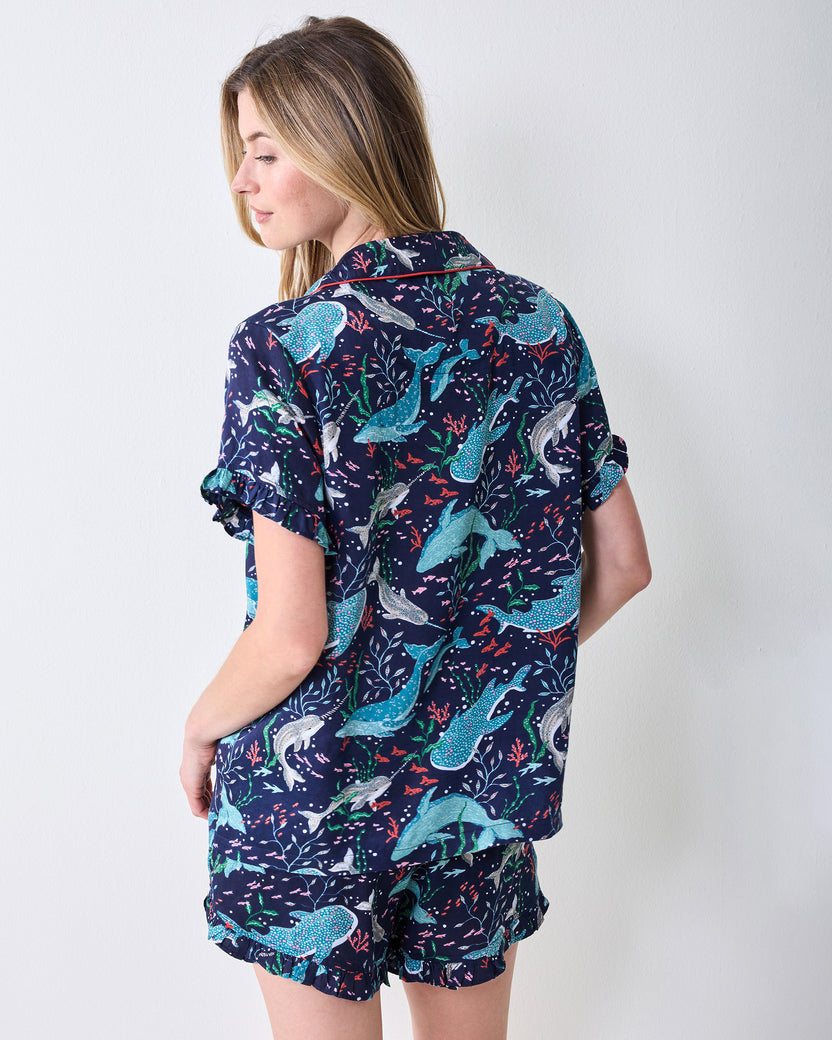 Back view of a navy Arctic sea-life print short-sleeved top and ruffle-trim shorts set