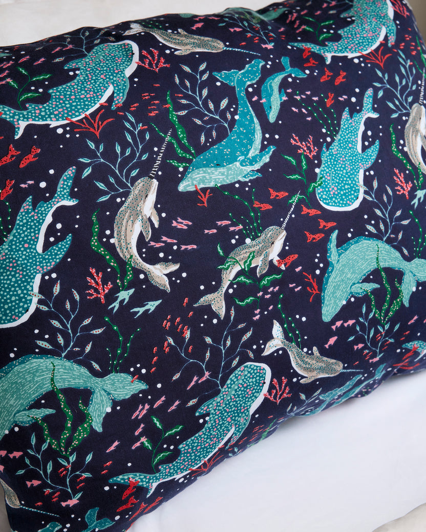 Close-up of the Arctic Sealife pillowcase print, showing turquoise and gray sea animals with coral and seaweed motifs on navy.