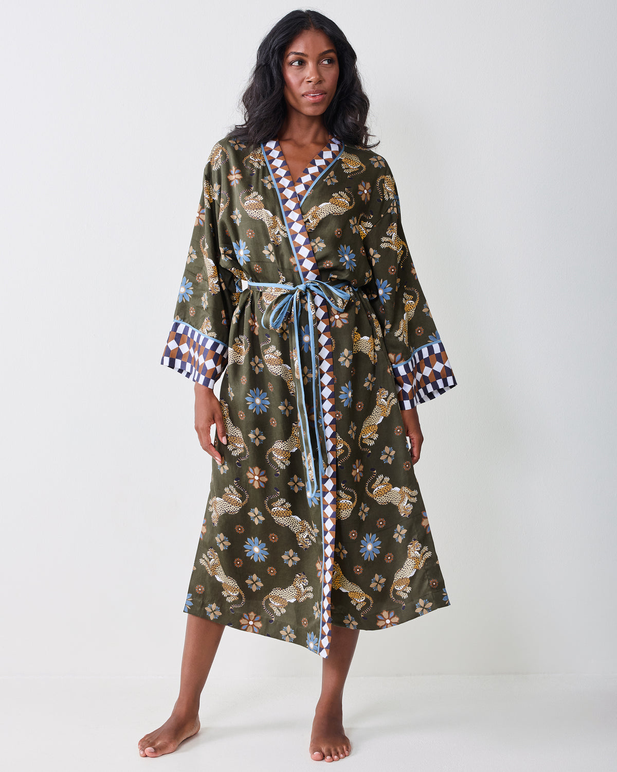 Full front view of the olive robe with leopard-and-floral print, wide sleeves, contrasting geometric trim, and a tied belt.
