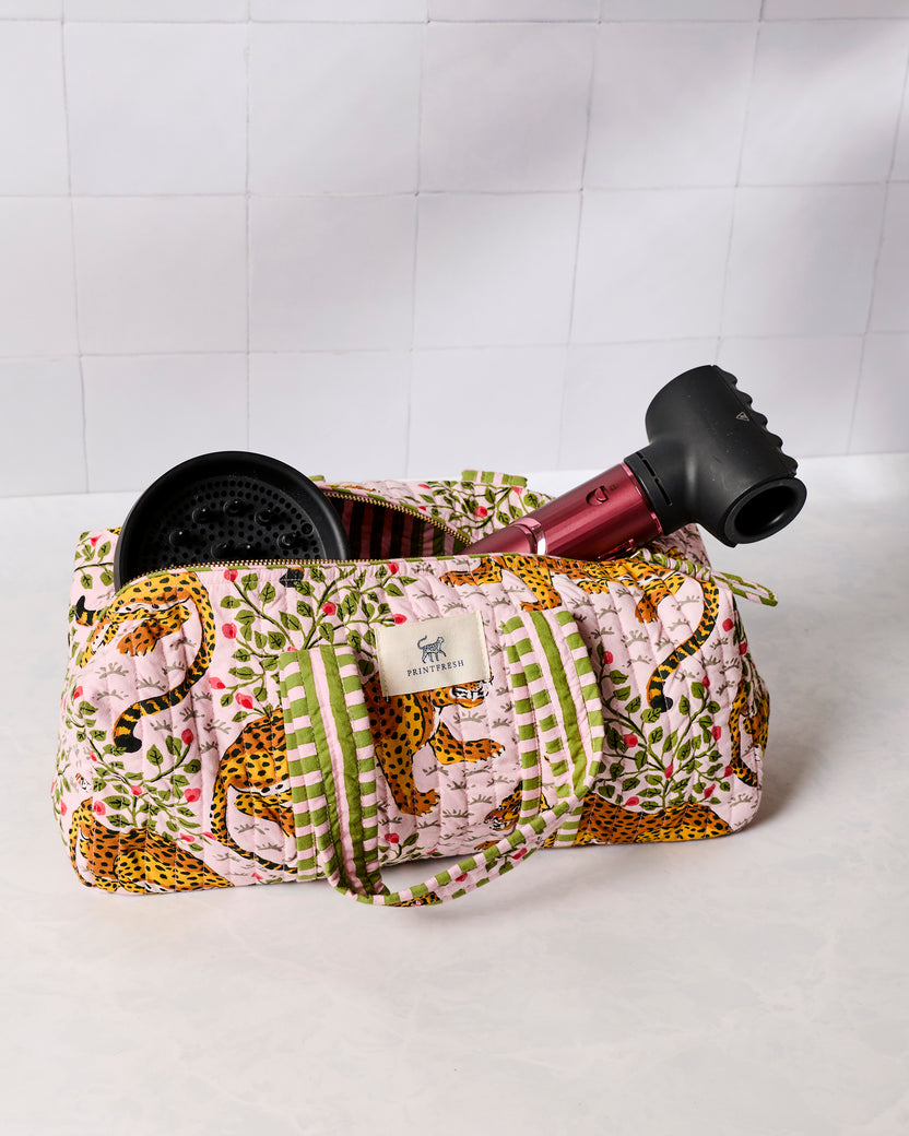 Open pink leopard-print quilted hair tool travel case holding a hair dryer and styling tool