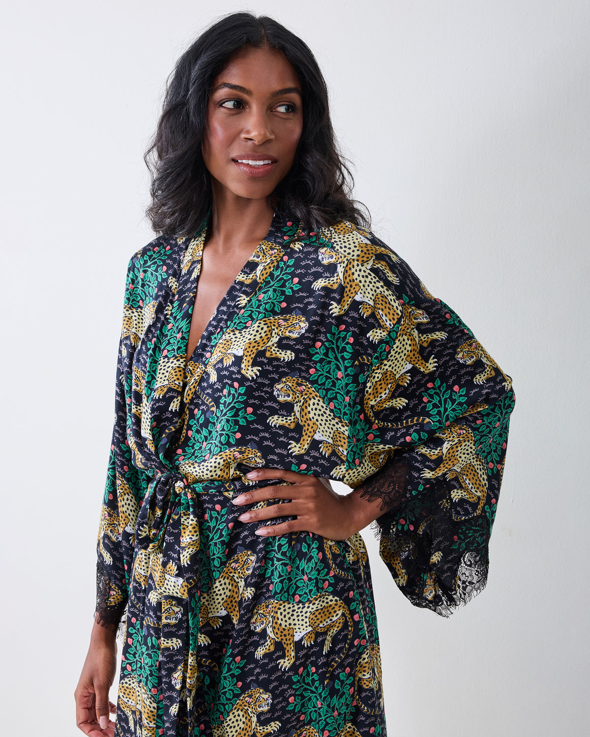 Front view of the Bagheera Eco Satin Lace Robe in Ink, showing the open neckline, belted waist, leopard-and-foliage print, and lace-trimmed sleeves.